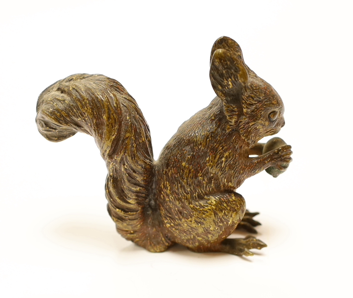 A large Austrian cold painted bronze of a squirrel eating a nut, 8cm high